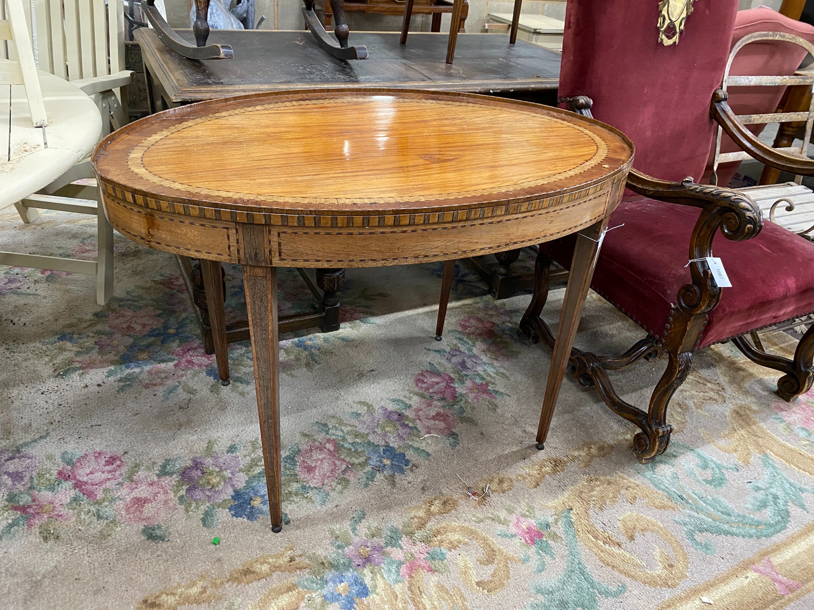 A George III Sheraton style oval banded satinwood centre table fitted drawer on square tapered legs, length 110cm, depth 70cm, height 75cm